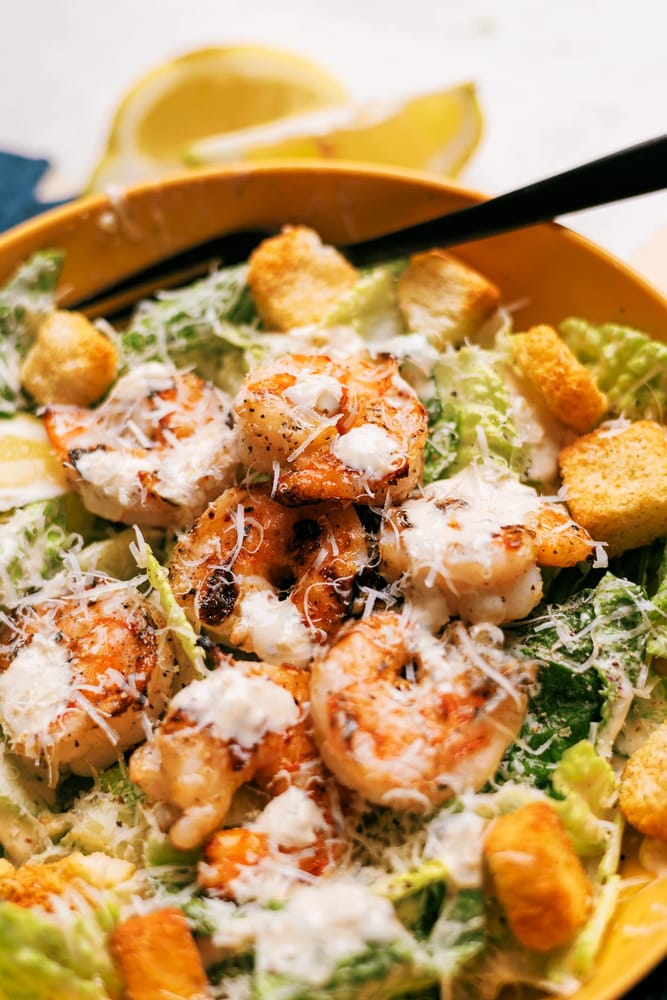 Caesar salad with grilled shrimp with crisp Romaine, lemon garlic marinated grilled shrimp and a creamy  homemade Caesar dressing.