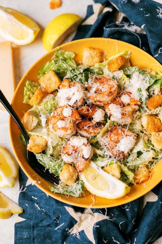 Caesar salad with grilled shrimp with crisp Romaine, lemon garlic marinated grilled shrimp and a creamy  homemade Caesar dressing.