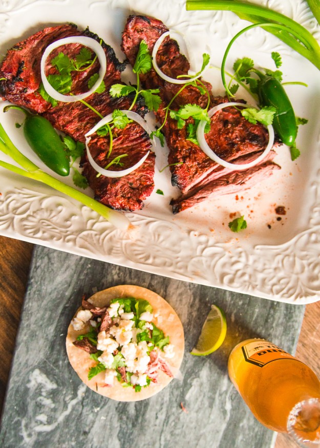 This carne asada beer marinade recipe uses a light beer and fresh citrus ingredients, with some heat and smokiness using cayenne jalapeno and smoked paprika.
