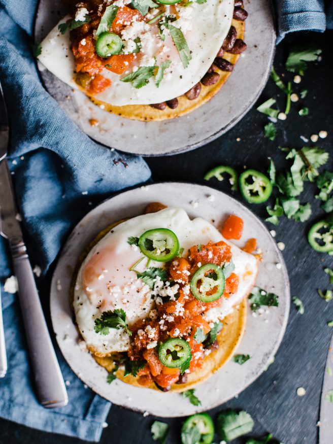 Huevos Rancheros Tostadas makes a great breakfast for dinner, or bunch meal. Topped with black beans, a from scratch salsa, then topped with a fried egg cojita cheese and serrano peppers