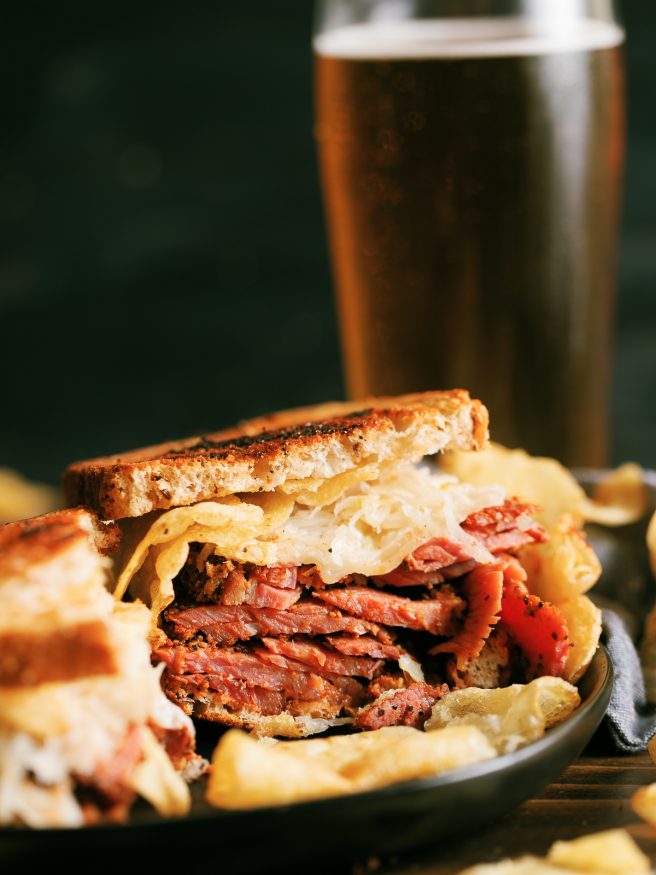 A Pastrami Reuben grilled on a panini press with crunchy kettle cooked chips. My absolute favorite way to do pastrami sandwiches!