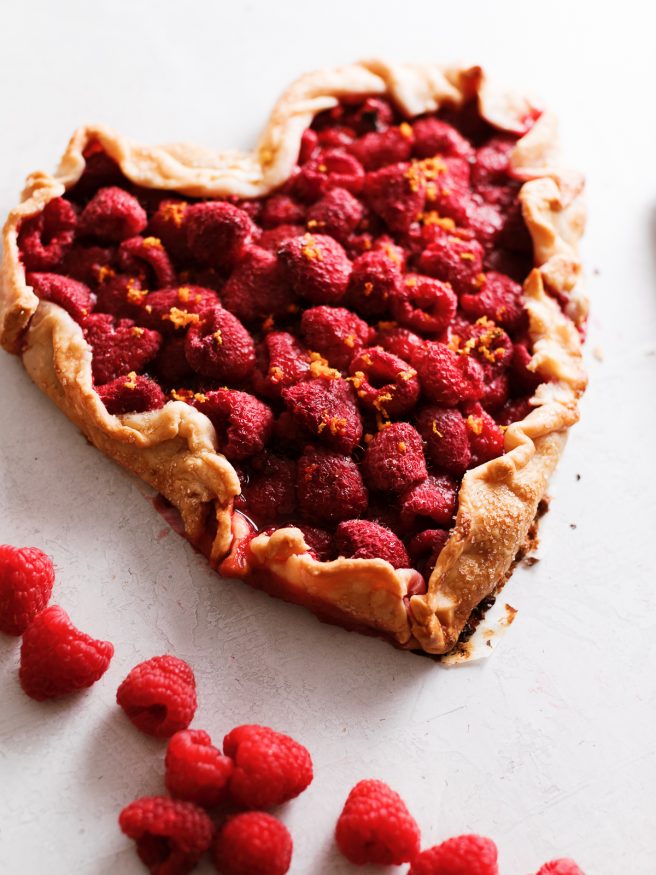 A raspberry galette in the shape of a heart. With raspberries, orange zest and a pre-made pie crust this makes the perfect Valentines Day dessert!