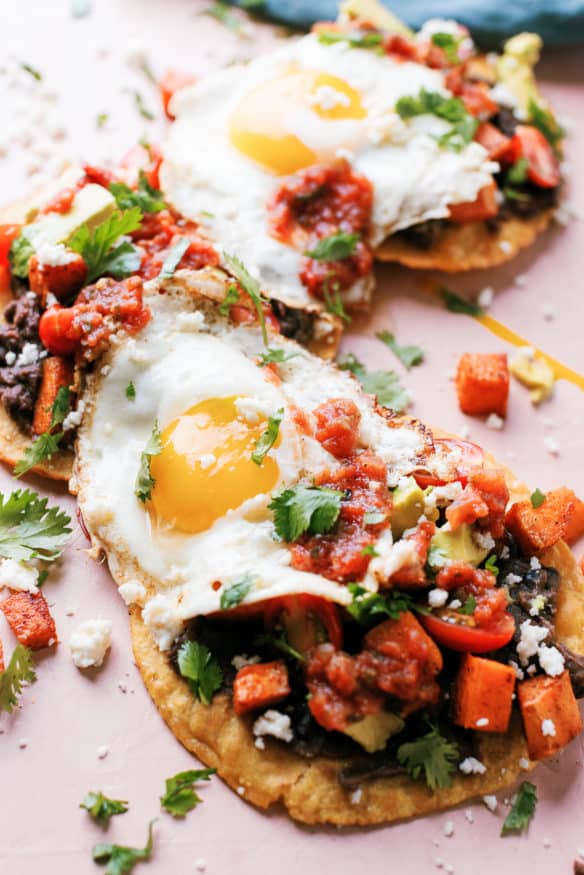 Huevos Rancheros Tostadas with some seasoned sweet potatoes on top makes the perfect breakfast, or breakfast for dinner recipe! 